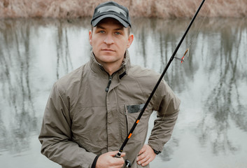 Fisherman standing with fishing rod