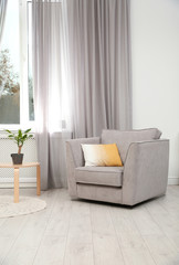 Modern furniture and window curtain in stylish room interior