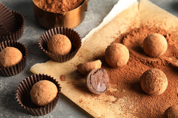 Composition with chocolate truffles on grey background