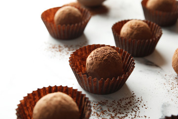 Tasty raw chocolate truffles on marble background