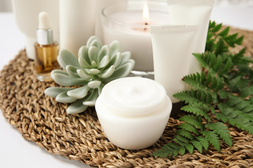 Composition with different body care products on wicker mat. Mockup for design