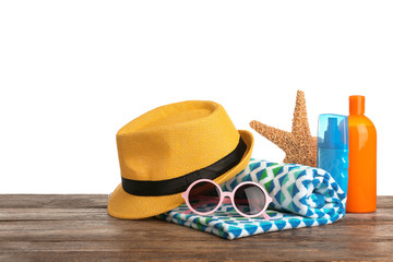Set of different beach accessories on table against white background. Space for text