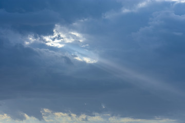 Fototapeta na wymiar Sun Ray Through Blue Cloudy Sky