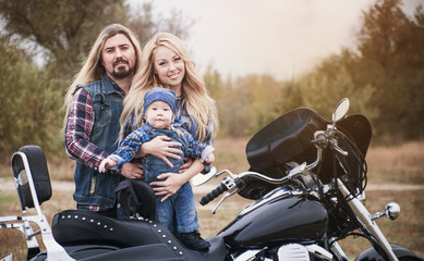 Naklejka na ściany i meble Happy bikers family has a fun outdoor. Father's Day concept. Mother's Day concept. Family look.