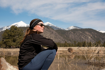 Female athlete enjoying the view with mountain peaks in the distance on a winter day
