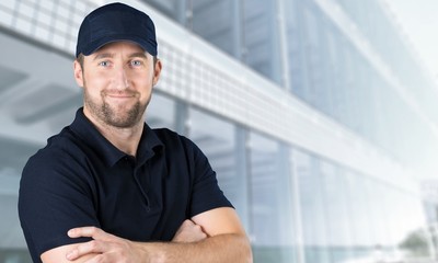 Handsome delivery man isolated on light background