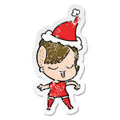 happy distressed sticker cartoon of a girl wearing santa hat