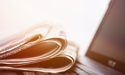 Newspapers on the laptop. Online news. Isolated