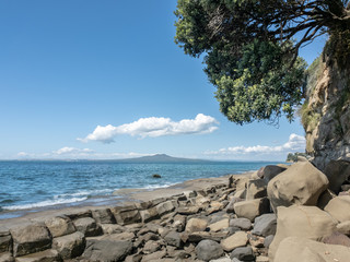 Rngitoto from the right side of mairangi bay beach with the high tide.