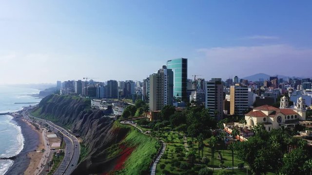 Aerial view of Miraflores shoreline including Domodossola park and Larcomar shopping mall. Clear and bright day, travel and destinations concept. Drone aerial shot of Lima's cityscape.