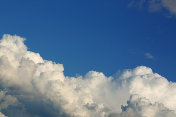 fluffy white cloud above clear blue sky background