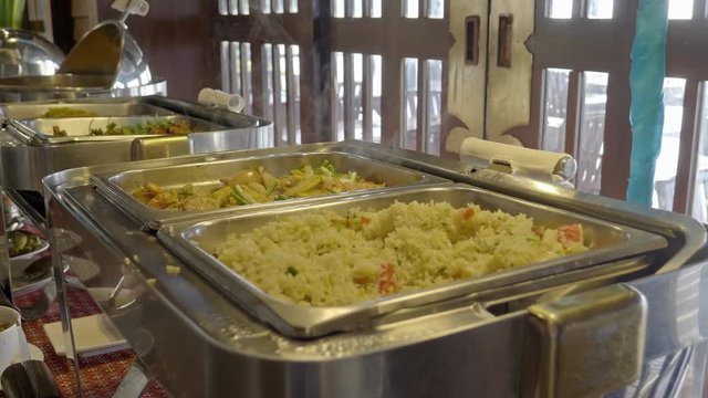 Steaming bain maries keeping rice and vegetables warm