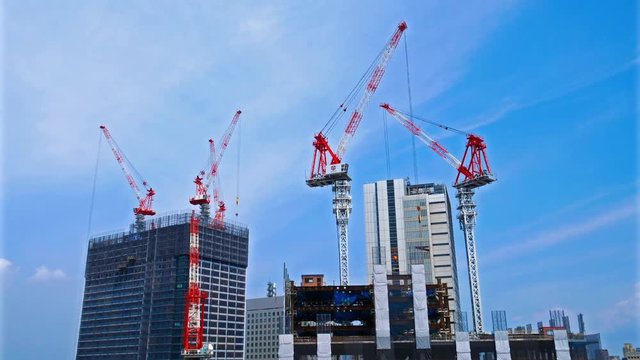 Timelapse of cranes working on a huge building construction