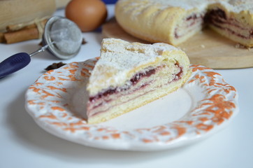 Homemade pie with cherry berries, cup of tea and fork on white wooden table. with ingredients for cooking, cinnamon, anise, icing sugar, topping. homemade baking. copy space. Top view.