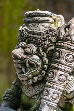 Traditional stone statue depicting demon, god and Balinese mythological deities in Ubud, island Bali, Indonesia , closeup