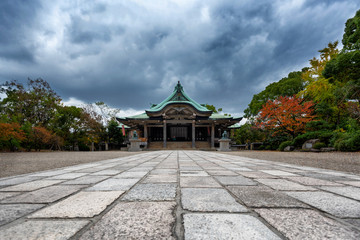 Fototapeta premium Scene at the Osaka Castle grounds on a cloudy day in Osaka, Japan with modern buildings in the background