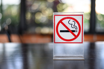 No smoking sign on wooden table in coffee shop Don't smoking place in public