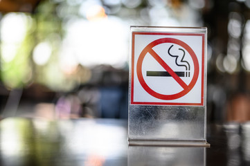No smoking sign on wooden table in coffee shop Don't smoking place in public