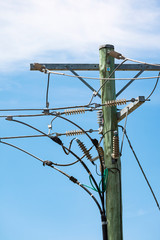 Power pole terminal high above street level on a summers day.
