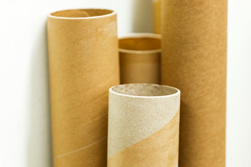 Cardboard postage tubes standing up straight.