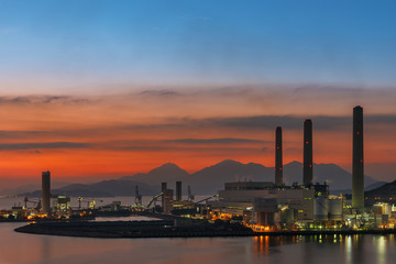 Naklejka premium Power plant in Hong Kong city at dusk