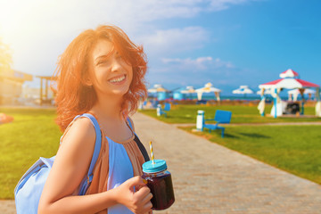 Woman in dress drinking smoothies
