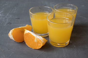 slice orange fruit on concrete table with glass juice