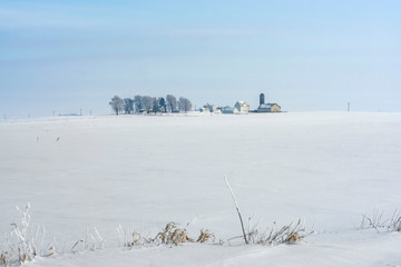 Farm field and farm house in winter time