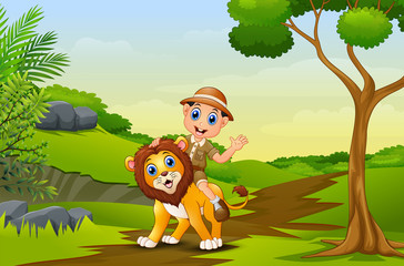 Obraz na płótnie Canvas Happy zookeeper boy and lion in a park