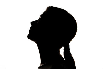 Dark silhouette profile of a young women on a white background, concept of anonymity