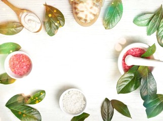 Close-up photo of fresh green leaves with aroma sea salt and brush on table