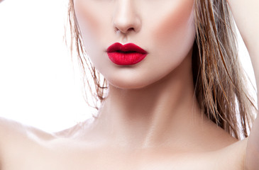 Close up red lips make-up of attractive young woman face over white background - cosmetic, wellness concept
