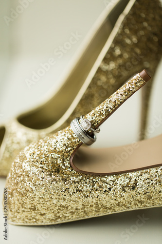 Wedding Rings On Gold Shoes Stock Photo And Royalty Free Images On