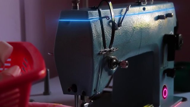 An Electric sewing machine. super advanced sewing machine with neon lights. highly creative shot!