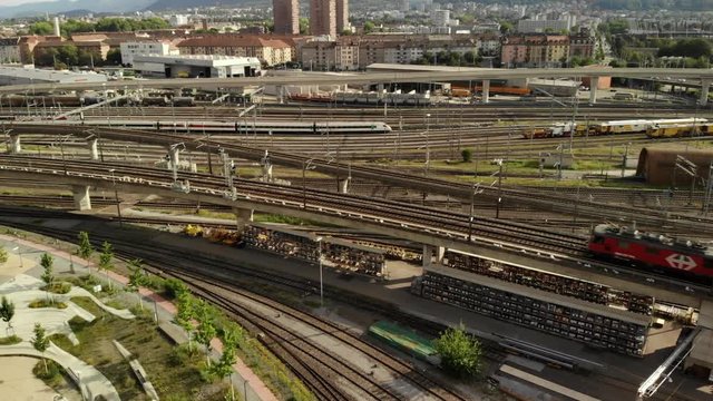 Drone shot panning left showing an SBB train passing by travelling towards Z&uuml;rich HB station in Switzerland