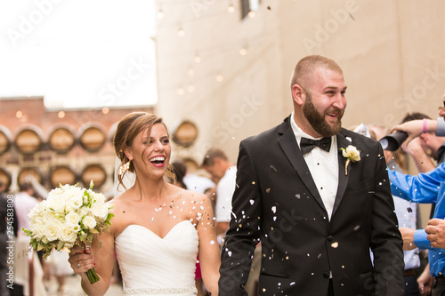 Smiling Bride and Groom with confetti
