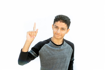 Fototapeta premium Portrait shot of a Caucasian teenager wearing a black colored full sleeves t-shirt and expressing or thinking about something serious or important by raising one of his hand .Isolated on white.