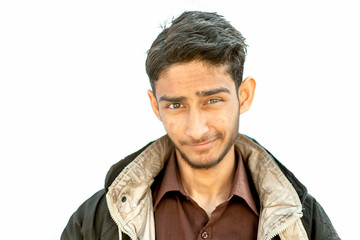 Obraz premium Portrait shot of young teenager beard wearing a maroon colored shirt and a black colored jacket expressing doubtfulness on his face isolated on white.