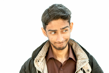 Obraz premium Portrait shot of young teenager beard wearing a maroon colored shirt and a black colored jacket expressing or making hilarious faces of expression of shock,surprise,fun,playfulness etc.