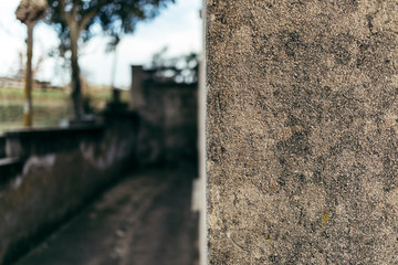Rough cement corner wall texture on an outdoor blurry background