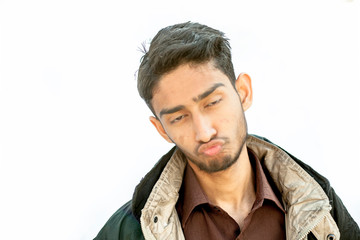 Portrait shot of young teenager beard wearing a maroon colored shirt and a black colored jacket expressing or making hilarious faces of expression of shock,surprise,fun,playfulness etc.