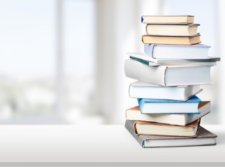 Colorful books collection on background.
