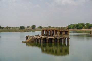 An old building in the middle of a lake in Jaisalmer, India