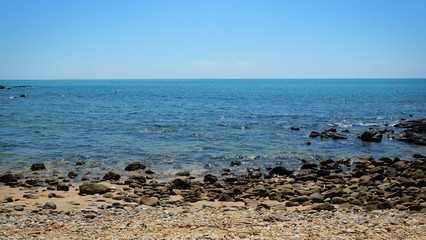 Fototapeta na wymiar Stone beach landscape on island at summer season.