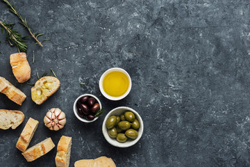 Obraz na płótnie Canvas Italian food Cooking Italian bruschetta Olives fresh baguette slices olive oil garlic rosemary