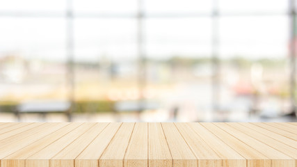 Wood table top on  with blur glass window wall background.