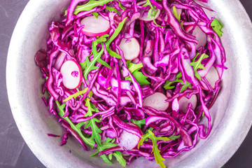 Obraz na płótnie Canvas Healthy salad with red cabbage, radish and arugula . Vegetarian concept