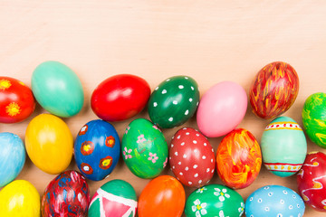 Fototapeta na wymiar Easter background with handmade colored eggs. Top view and copy space. Festive tradition