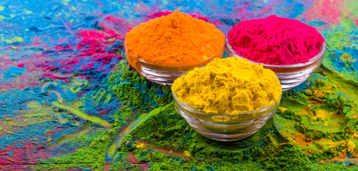 Holi color powder. Organic Gulal colours in bowl for Holi festival, Hindu tradition festive. Bright vibrant pigment closeup