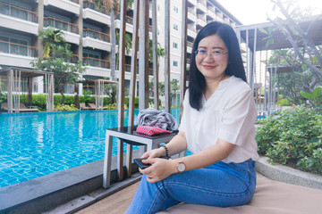 Asian beautiful women with swimming pool of hotel resort